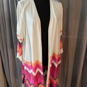 Hip length cardigan with split seam at hip.